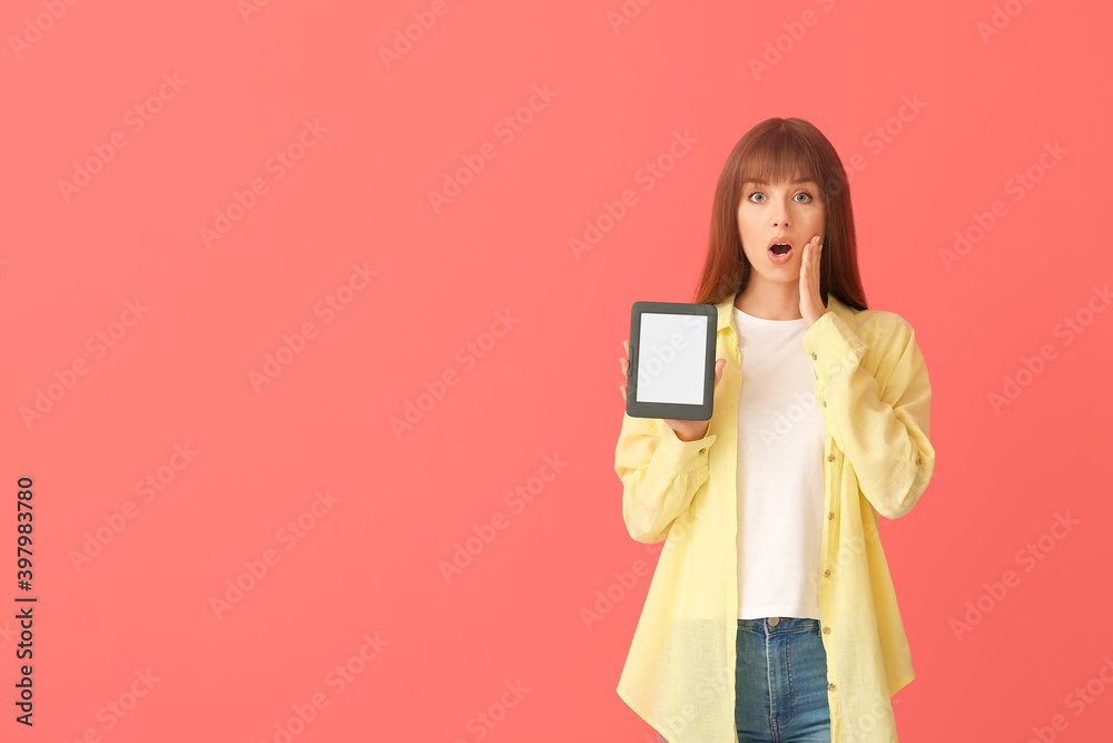 Surprised young woman with e-reader on color background Surprised young woman with e-reader on color background