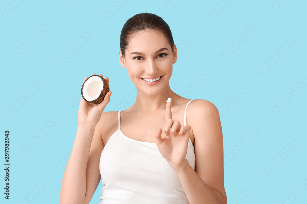 Beautiful young woman with coconut oil on color background Beautiful young woman with coconut oil on color background