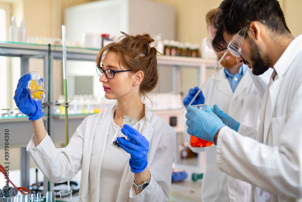 Group of medical scientists working at the laboratory. Research virus people concept Group of medical scientists working at the laboratory. Research virus people concept