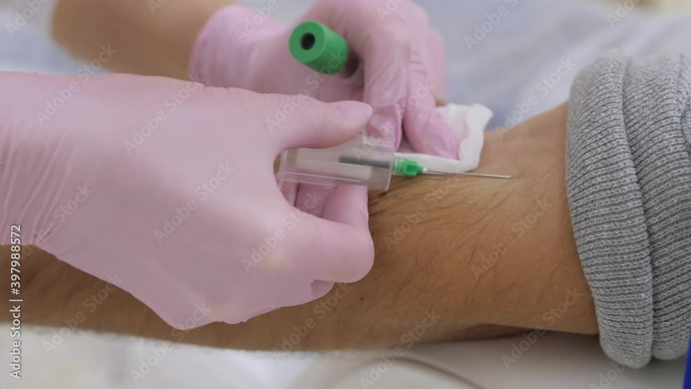 Laboratory with nurse taking a blood sample from patient close up Laboratory with nurse taking a blood sample from patient close up
