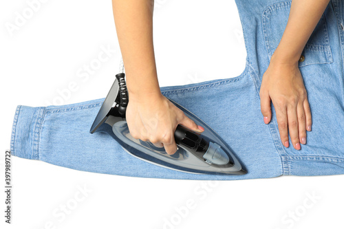 Woman ironing jeans, isolated on white background
