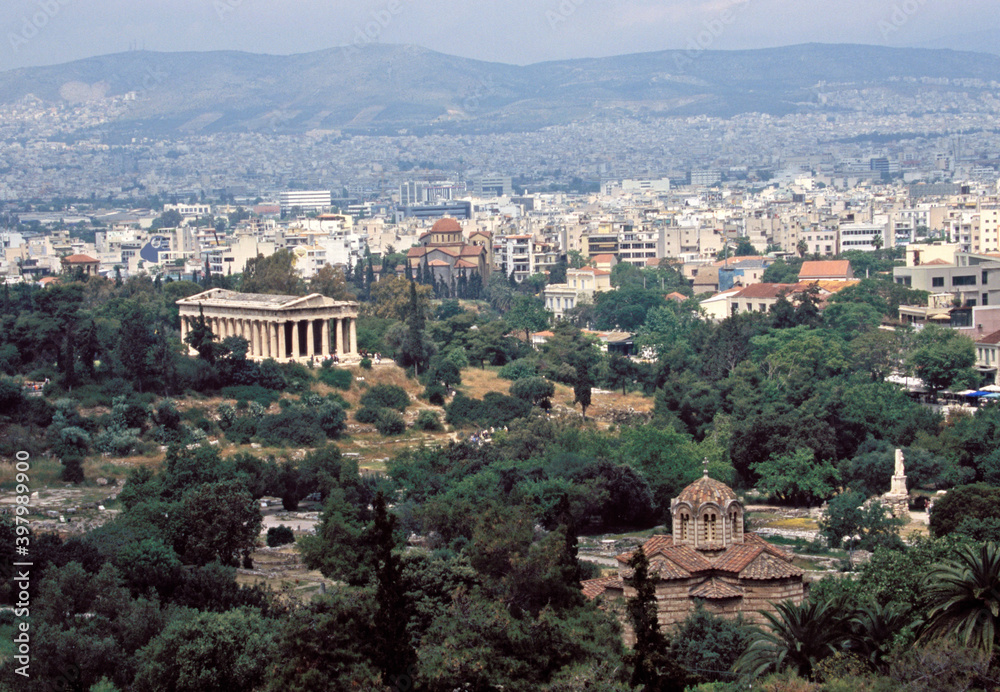 Aerial View of Temple of Hephaestus and ruins with cityscape in Ancient Agora of Athens, Greece.