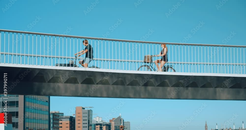 Busy cyclist bridge with bike lane in central Copenhagen or Amsterdam. European cycling capital city, move towards sustainability and green ecological nature friendly future. Low co2 emissions 