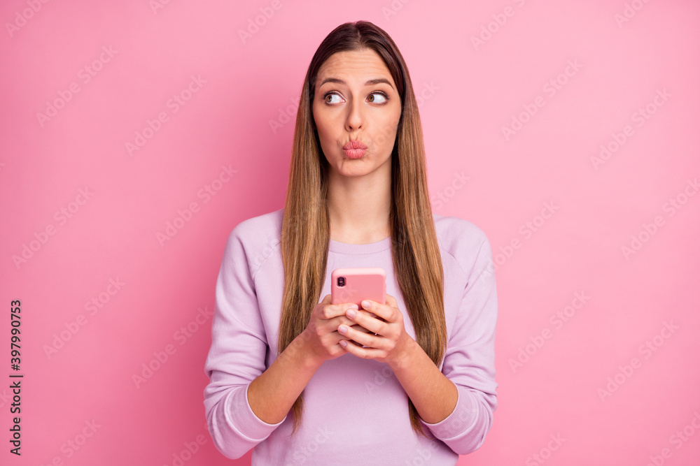 Close-up portrait of pretty girlish straight-haired girl using cell app pout lips isolated over pink pastel color background Close-up portrait of pretty girlish straight-haired girl using cell app pout lips isolated over pink pastel color background