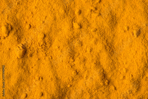 Indian spice turmeric. Close up view photo of textured backdrop of light color curcuma powder photo