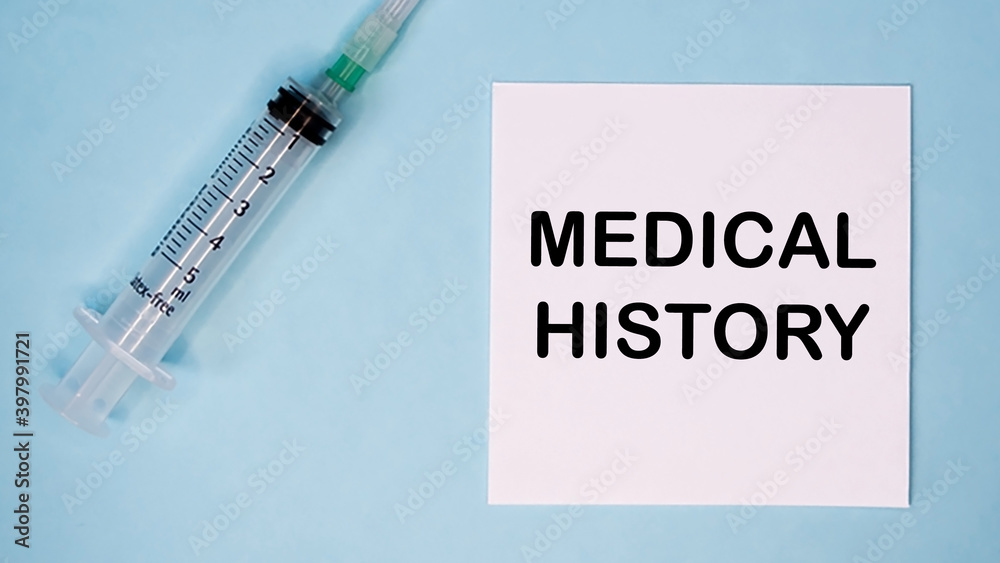 'Medical history' message on sticker with syringe near. Medical concept. 'Medical history' message on sticker with syringe near. Medical concept.
