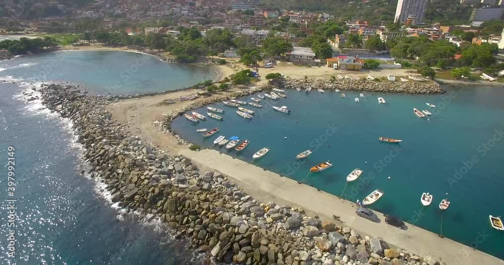 Drone shot view of the breakwater coastline and marina in the calm Caribbean Sea