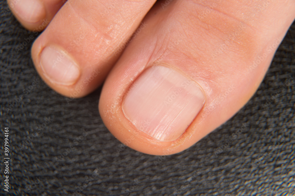 Close-up shot of beautiful woman feet with natural pedicure Close-up shot of beautiful woman feet with natural pedicure