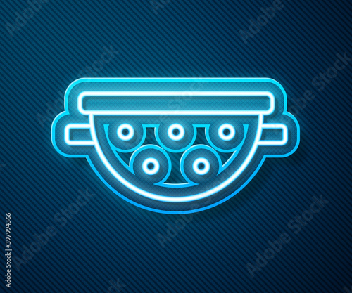 Glowing neon line Kitchen colander icon isolated on blue background. Cooking utensil. Cutlery sign. Vector.