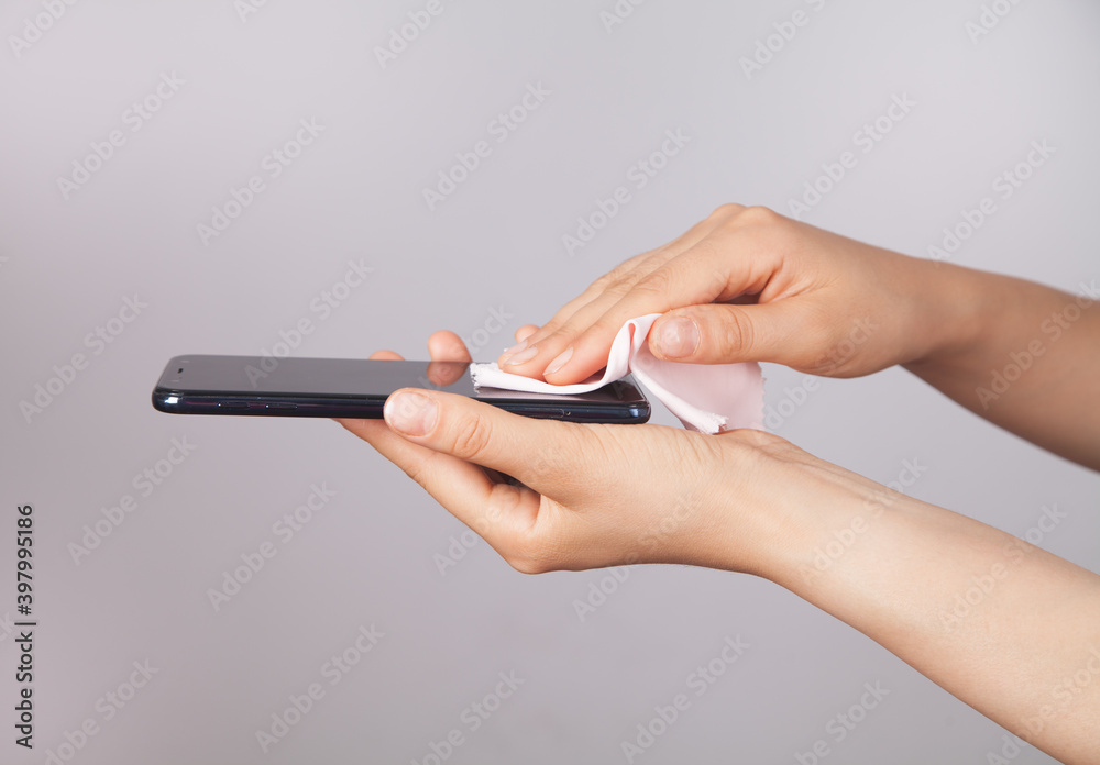 Woman cleaning mobile phone screen. Woman cleaning mobile phone screen.