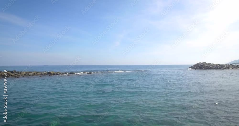 Drone shot view of the breakwater coastline in the calm Caribbean Sea