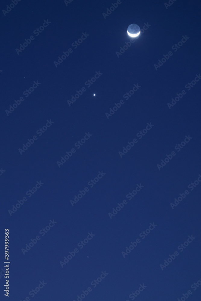 Astronomical conjunction of Venus and Moon, photographed with long focal lens. Astronomical conjunction of Venus and Moon, photographed with long focal lens.
