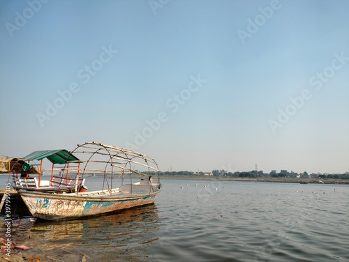 Prayagraj, Uttar Pradesh India- November 21 2020: Old wooden boats are floating near the shore of the holy river- Ganges.