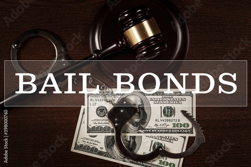 Judge gavel, handcuffs and money - Bail bonds services concept.