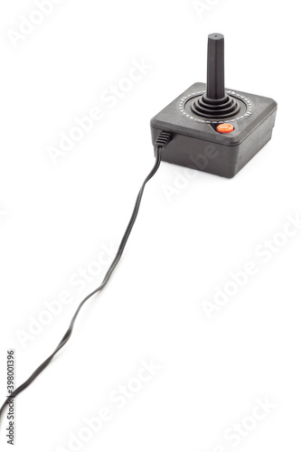 Retro joystick with one orange button. Studio photo isolated on white background. photo