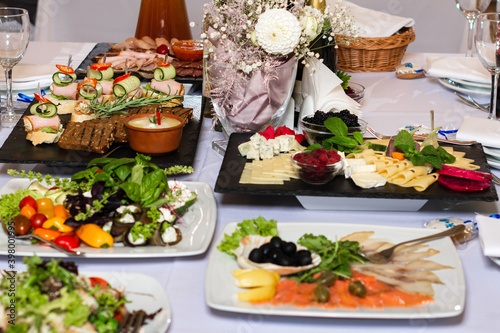 Table setting  food and decorations for important and family events  delicious snacks and hot dishes.