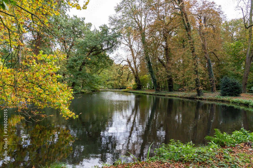 A small lake surrounded by trees in autumn colors near Linschoten