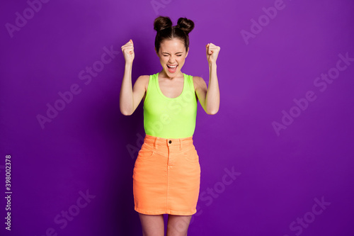 Photo of ecstatic girl raise fists scream lottery win wear tank-top isolated over bright purple color background