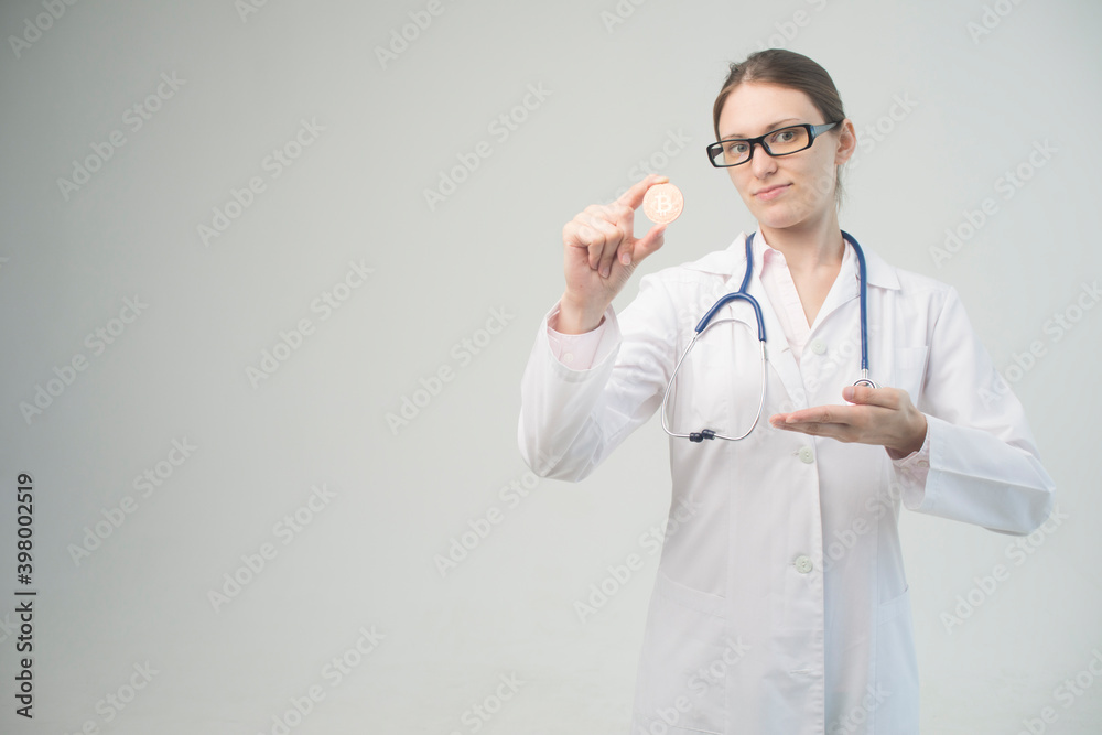 young doctor holds bitcoin in hand young doctor holds bitcoin in hand