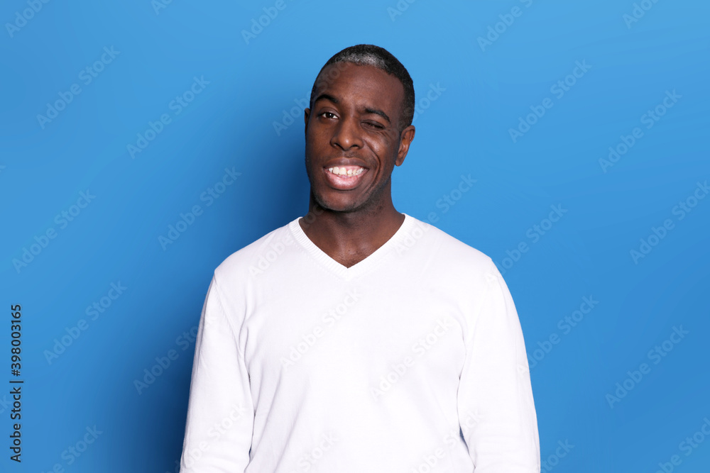 American business man wearing white shirt and tie over isolated white background winking looking at the camera with sexy expression, cheerful and happy face. American business man wearing white shirt and tie over isolated white background winking looking at the camera with sexy expression, cheerful and happy face.