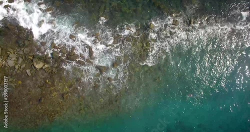 Bird eye view of a rock breakwater and waves hitting against it photo