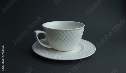 White tea Cup and saucer on a black background