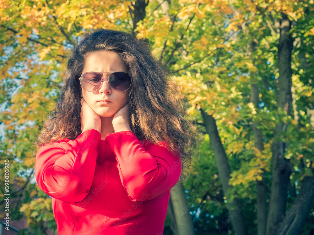 Portrait of frightened scared woman brunette teenager, surprised teenager girl looking down outdoors in a park Portrait of frightened scared woman brunette teenager, surprised teenager girl looking down outdoors in a park