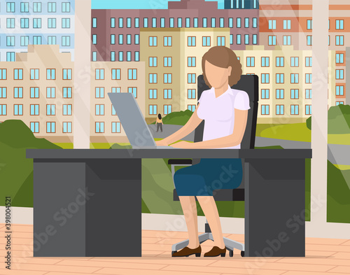 Young business woman at the desk is working on the laptop computer with the big panoramic window with cityscape behind. Secretary in office workspace, businesswoman person, trainee typing on keyboard