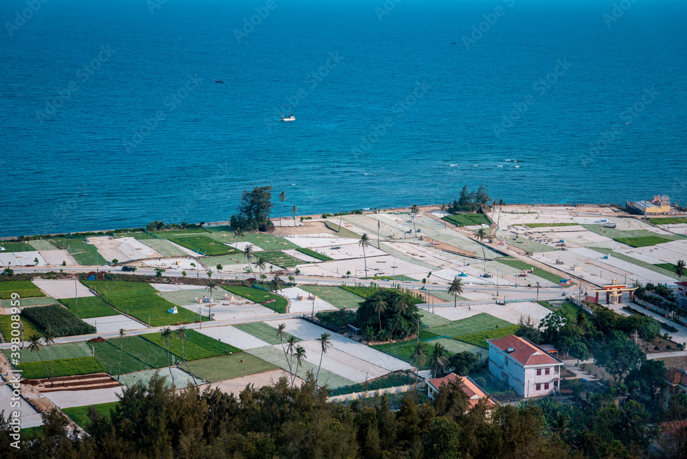 high view from Thoi Loi Mountain, fishing village and garlic fields at Ly Son island, Quang Ngai Province, Viet Nam