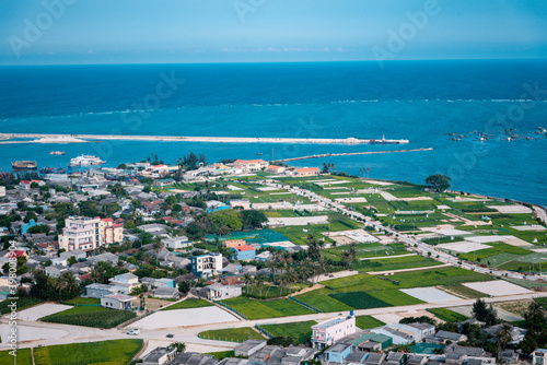 high view from Thoi Loi Mountain, fishing village and garlic fields at Ly Son island, Quang Ngai Province, Viet Nam © Nhan