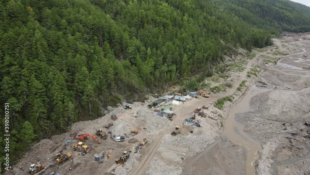 View from above. 4K. A dirty river in a mine among green mountains. Ecological catastrophy. The prospectors base stands on a destroyed speech among the green mountains View from above. 4K. A dirty river in a mine among green mountains. Ecological catastrophy. The prospectors base stands on a destroyed speech among the green mountains