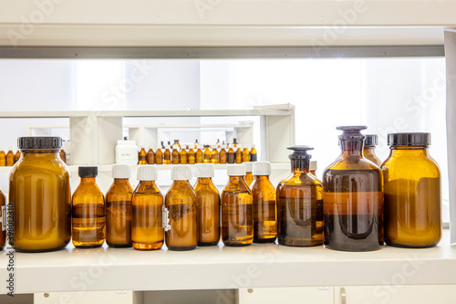 Close up amber color bottles in laboratory. Amber bottle for storing scientific samples. photo