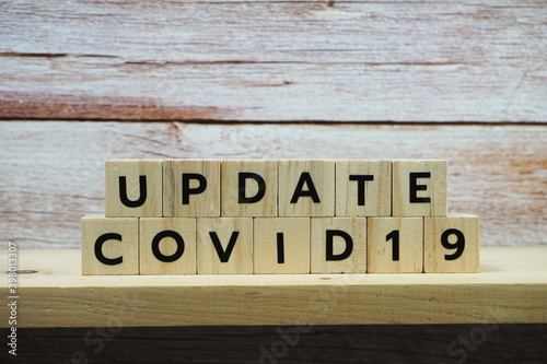 Update Covid-19 alphabet letter on wooden background