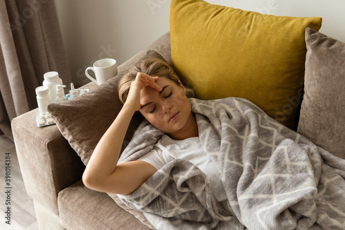 Sick woman suffering from headache at home