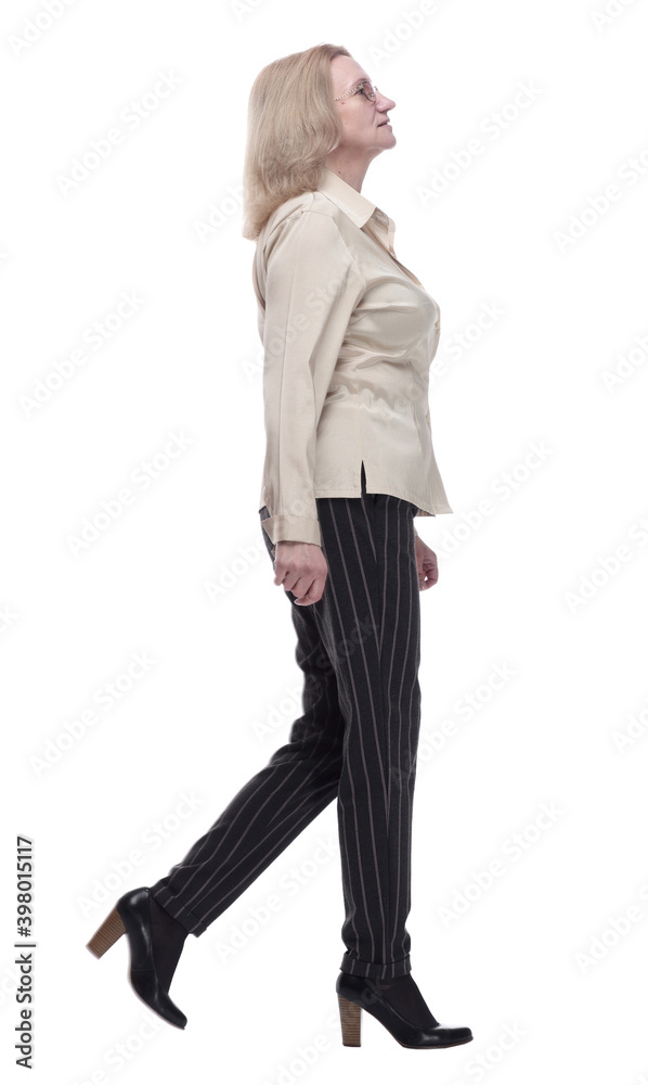 Fototapeta premium confident woman in fashionable trousers striding forward
