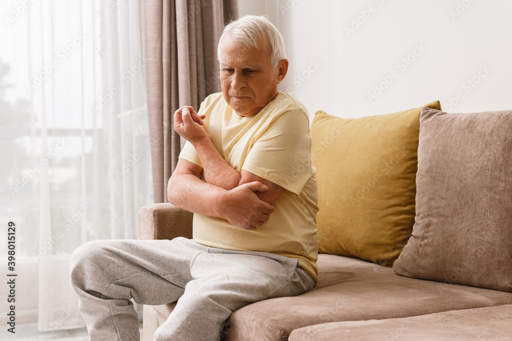 Senior man suffering from pain in his elbow Senior man suffering from pain in his elbow