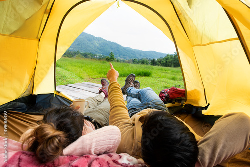 couple lying rest inside the tent in outdoor lifestyle adventure hike camping. Travel Concept. different lifestyle concept © chotiga