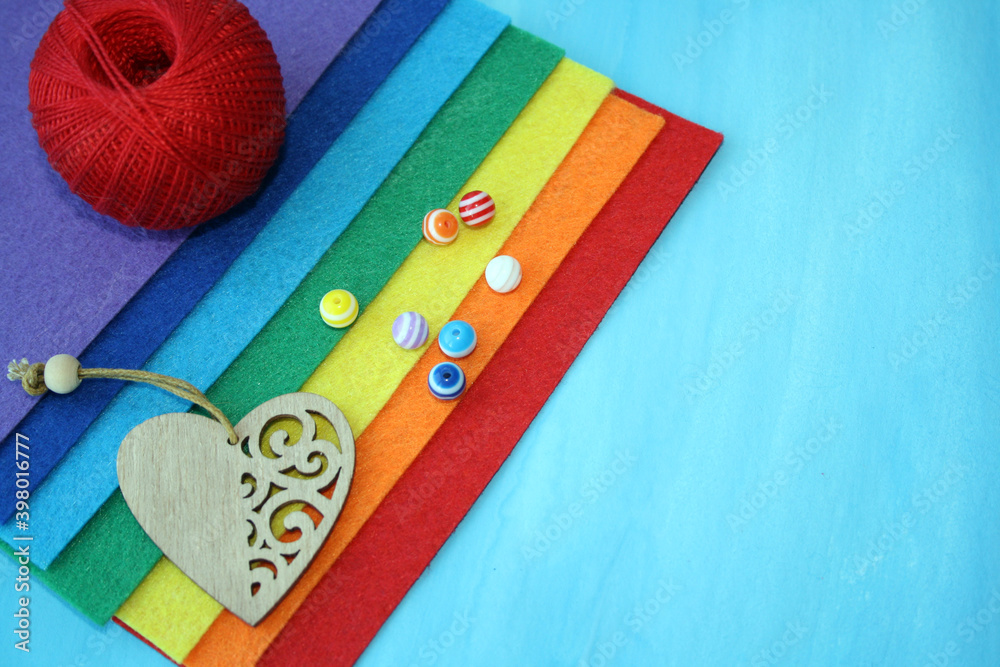 Beads on a colorful felt on a blue background. Beads on a colorful felt on a blue background.