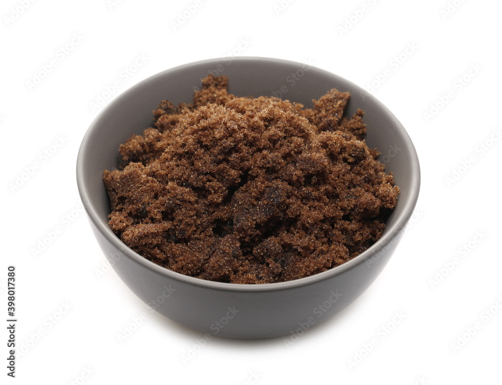 Sugar muscovado in porcelain bowl isolated on white background Sugar muscovado in porcelain bowl isolated on white background
