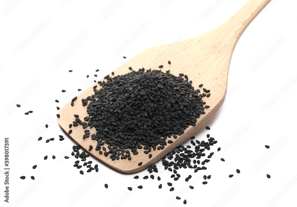 Black sesame seeds pile with wooden spoon isolated on white background Black sesame seeds pile with wooden spoon isolated on white background