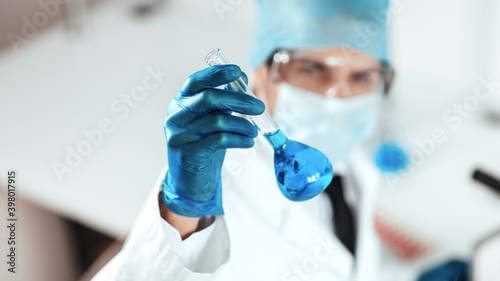 close up. medical flask in the hands of the researcher.