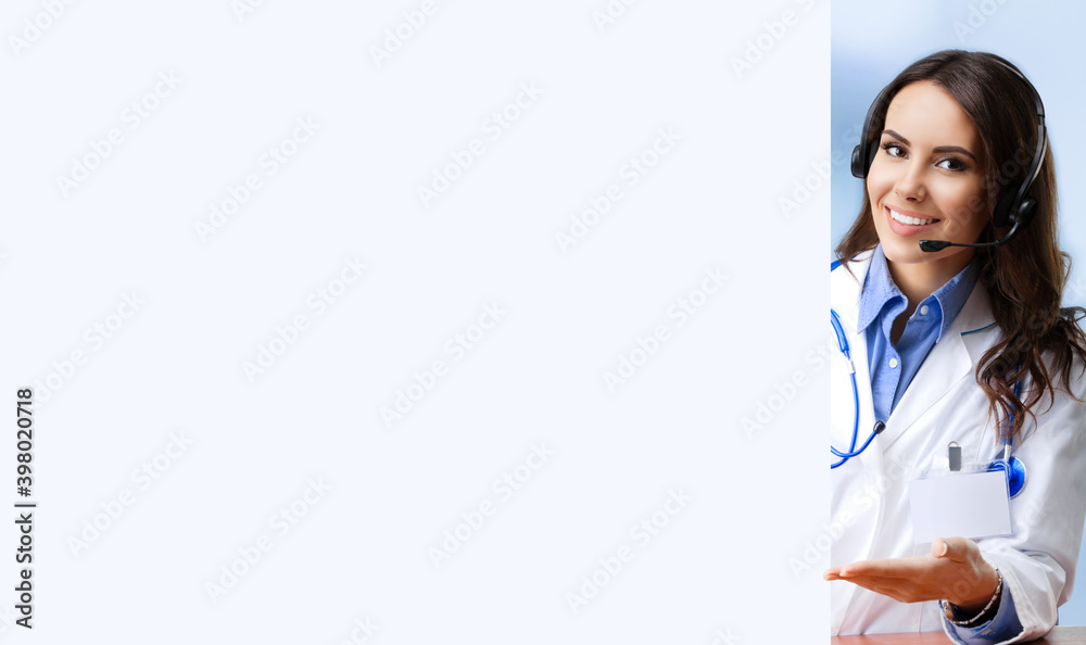 Smiling female doctor in phone headset, showing empty sign board with copy space blank area for text. Medical call center, clinic, consulting, consultation, help answering. Smiling female doctor in phone headset, showing empty sign board with copy space blank area for text. Medical call center, clinic, consulting, consultation, help answering.
