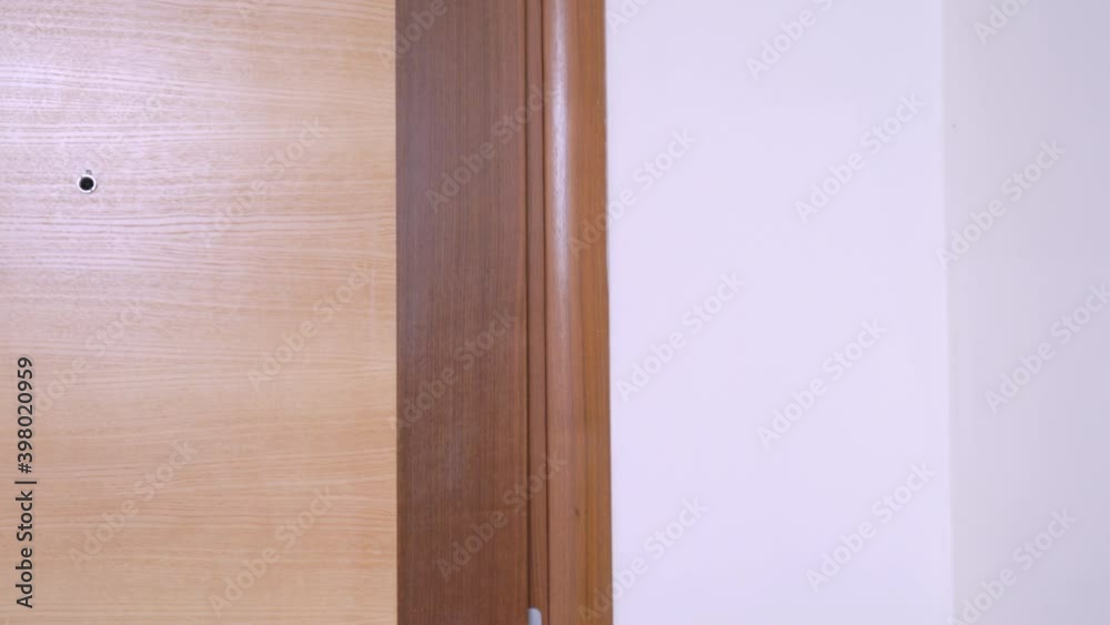 Sad young man looks out from behind the door to room and asks for something with pleading look and with hands clasped in front of him in supplication. Then he disappears into doorway. Sad young man looks out from behind the door to room and asks for something with pleading look and with hands clasped in front of him in supplication. Then he disappears into doorway.