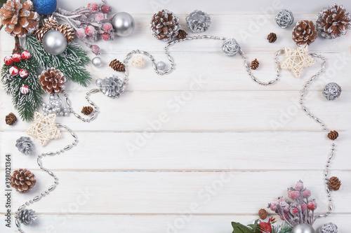 Сhristmas ball and fir cones decor on white wooden background. New Year theme. Close up