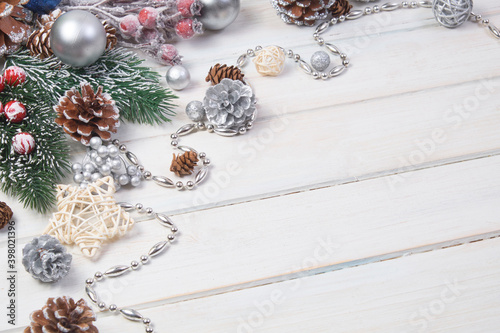 Сhristmas ball and fir cones decor on white wooden background. New Year theme. Close up