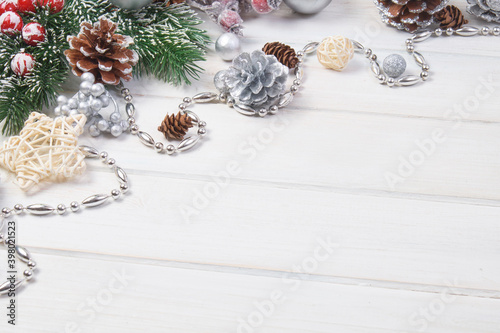 Сhristmas ball and fir cones decor on white wooden background. New Year theme. Close up