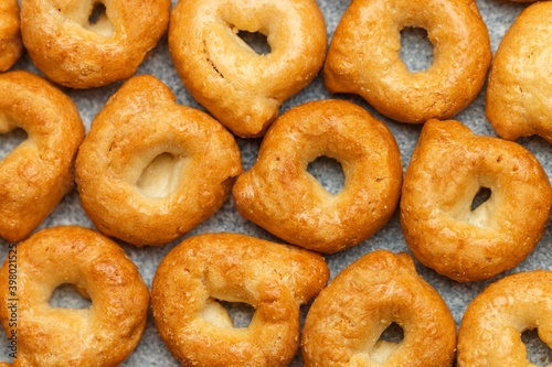 Tarallini-traditional Italian small bagels. Taralli. Delicious snack close-up. Culinary background. Selective focus, top view