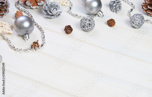 Сhristmas ball and fir cones decor on white wooden background. New Year theme. Close up