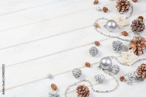 Сhristmas ball and fir cones decor on white wooden background. New Year theme.