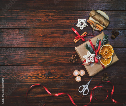 Christmas background with copy space. Gift boxes and decor on wooden background.